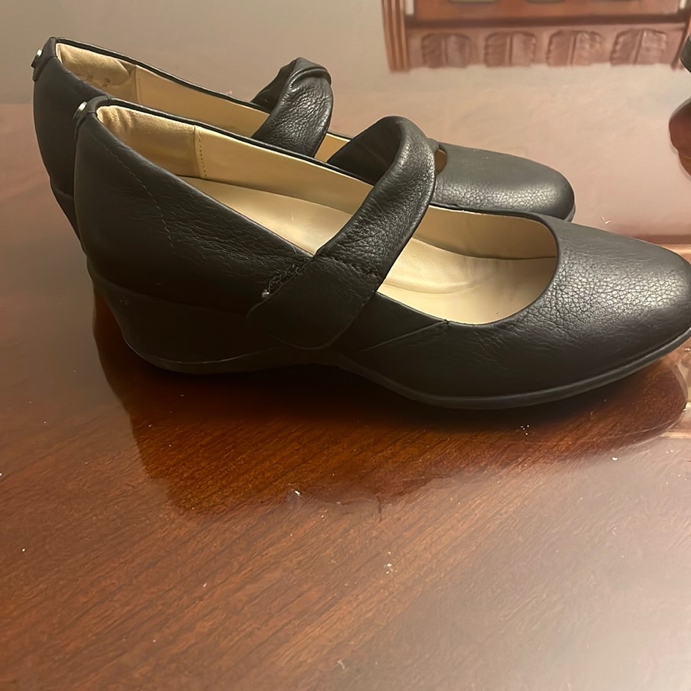 Black pair of Hush Puppies platform shoes.